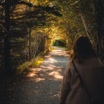 woman-walking-park-path