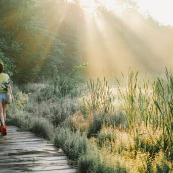 Woman walking outdoors in a peaceful environment.